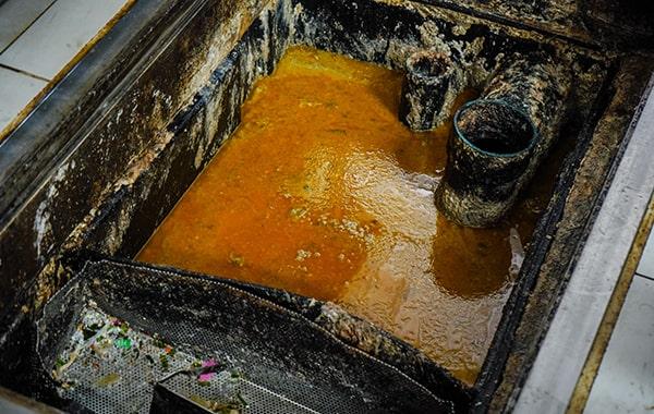 throughout grease trap cleaning, the trap is cleared, scraped, and cleaned to remove built-up grease and solids